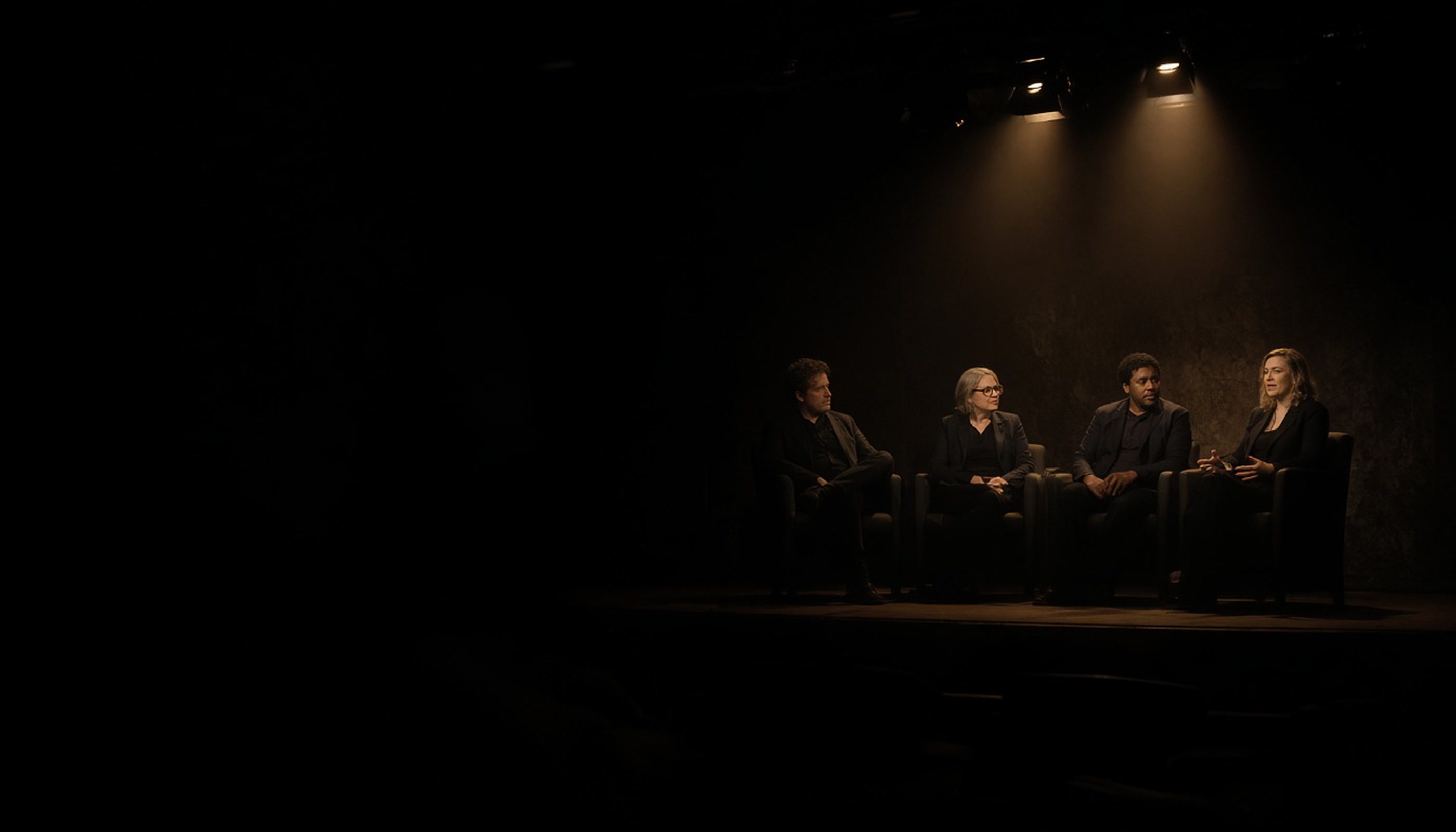 Year-one panel on a dark conference stage